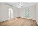 Spacious bedroom with neutral walls, a ceiling fan, a large window, and wood-look floors at 30260 Birdhouse Dr, Wesley Chapel, FL 33545