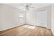 Bedroom featuring wood-look flooring, a ceiling fan, and natural light at 30260 Birdhouse Dr, Wesley Chapel, FL 33545