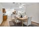 Open dining area with a modern table set, adjacent to the kitchen and living spaces at 30260 Birdhouse Dr, Wesley Chapel, FL 33545