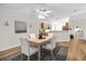 Cozy dining area showcasing a modern table set, an elegant ceiling fan, and wood-look flooring at 30260 Birdhouse Dr, Wesley Chapel, FL 33545