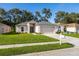 Charming single-story home featuring a well-manicured lawn, a two-car garage and a welcoming front entrance at 30260 Birdhouse Dr, Wesley Chapel, FL 33545