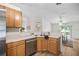Kitchen featuring wooden cabinets, stainless steel appliances, and view into the dining area at 30260 Birdhouse Dr, Wesley Chapel, FL 33545