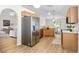 Bright, functional kitchen with stainless steel refrigerator, wooden cabinets, and open layout at 30260 Birdhouse Dr, Wesley Chapel, FL 33545
