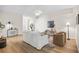 Bright living room featuring neutral decor, ceiling fan, and wood-look flooring at 30260 Birdhouse Dr, Wesley Chapel, FL 33545