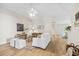 Bright living room with neutral tones, stylish furniture, wood-look flooring and an elegant area rug at 30260 Birdhouse Dr, Wesley Chapel, FL 33545