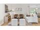 Bright living room with neutral tones, stylish furniture, wood-look flooring and an elegant area rug at 30260 Birdhouse Dr, Wesley Chapel, FL 33545