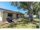 A well-kept backyard has a patio, lush lawn and mature trees providing shade at 3226 Coventry N, Safety Harbor, FL 34695