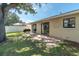 A spacious backyard features a brick patio, lush lawn, and sliders to the home at 3226 Coventry N, Safety Harbor, FL 34695