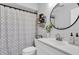 Clean bathroom with modern fixtures, decorative elements, and a stylish shower curtain at 3226 Coventry N, Safety Harbor, FL 34695