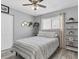 Bright bedroom with a decorative bed, shelves, and a window providing plenty of natural light at 3226 Coventry N, Safety Harbor, FL 34695