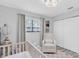 Inviting Bedroom with a crib, rocker, and soft rug, perfect for a peaceful environment at 3226 Coventry N, Safety Harbor, FL 34695
