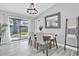 Charming dining room with wood table, chandelier lighting, and sliding glass doors to the backyard at 3226 Coventry N, Safety Harbor, FL 34695