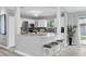 Well-lit kitchen with white cabinetry, breakfast bar, and stainless steel appliances at 3226 Coventry N, Safety Harbor, FL 34695