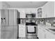 Modern kitchen with stainless steel appliances, white cabinets, and bright lighting at 3226 Coventry N, Safety Harbor, FL 34695