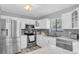 Well-appointed kitchen with stainless steel appliances, white cabinets, and modern finishes at 3226 Coventry N, Safety Harbor, FL 34695