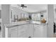 Bright, open kitchen with marble countertops and breakfast bar overlooking the living area at 3226 Coventry N, Safety Harbor, FL 34695
