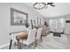 Bright living room with wood-look tile flooring, comfortable seating, and an elegant dining area at 3226 Coventry N, Safety Harbor, FL 34695