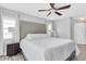 Spacious main bedroom featuring a tufted headboard, ceiling fan, and abundant natural light at 3226 Coventry N, Safety Harbor, FL 34695