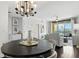 Contemporary dining area with dark wood floors, chandelier, and city skyline views at 345 Bayshore Blvd # 1510, Tampa, FL 33606