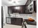 Modern kitchen with stainless steel appliances, dark cabinets, and marble countertops at 345 Bayshore Blvd # 1510, Tampa, FL 33606