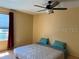 Bedroom with ceiling fan, window, wood floor, neutral walls, and a comfortable bed at 3535 41St S Ter # 219, St Petersburg, FL 33701
