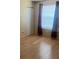 Bright bedroom featuring hardwood floors, a closet, and a large window for natural light at 3535 41St S Ter # 219, St Petersburg, FL 33701