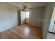 Cozy dining area featuring a classic chandelier, wood flooring, and views of kitchen appliances at 3535 41St S Ter # 219, St Petersburg, FL 33701