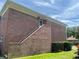 Brick condo featuring stairs to a second-story entry, set against a backdrop of a sunny sky at 3535 41St S Ter # 219, St Petersburg, FL 33701