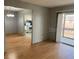 Bright living room featuring beautiful wood flooring and a sliding glass door to a balcony at 3535 41St S Ter # 219, St Petersburg, FL 33701