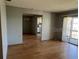 Bright living room featuring beautiful wood flooring and a sliding glass door to a balcony at 3535 41St S Ter # 219, St Petersburg, FL 33701