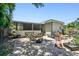 Backyard concrete patio and screened porch surrounded by shrubbery, yard equipment, and debris at 3601 27Th S Ave, St Petersburg, FL 33711