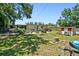 Backyard featuring lawn, utility trailer, red car, and storage shed at 3601 27Th S Ave, St Petersburg, FL 33711