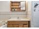 Bathroom with vanity, shower, tile walls, built-in storage, and hardware at 3601 27Th S Ave, St Petersburg, FL 33711