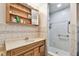 Bathroom with vanity, shower, tile walls, built-in storage, and hardware at 3601 27Th S Ave, St Petersburg, FL 33711