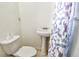 A half bathroom has pedestal sink, toilet and a decorative shower curtain at 3601 27Th S Ave, St Petersburg, FL 33711