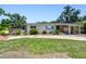 Inviting single-story home showcasing stone details, a covered carport, and a neatly kept front yard at 3601 27Th S Ave, St Petersburg, FL 33711