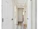 Hallway with gray laminate flooring and white doors offers passage to other rooms at 3601 27Th S Ave, St Petersburg, FL 33711