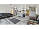 Spacious open-concept living area featuring modern gray flooring and a glimpse into the updated kitchen at 3601 27Th S Ave, St Petersburg, FL 33711