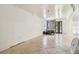 An empty living room with ceramic tile flooring, stone decor, and a front door with oval window at 3601 27Th S Ave, St Petersburg, FL 33711