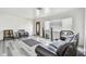Inviting living room with wood-look flooring, a cozy couch, and plenty of natural light from the window at 3601 27Th S Ave, St Petersburg, FL 33711