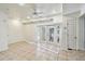 A large empty living room with tile flooring, ceiling fan, recessed lights and french doors at 3601 27Th S Ave, St Petersburg, FL 33711