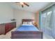 Cozy bedroom with hardwood furniture, blue accents, and natural light from a window at 367 Countryside Key Blvd, Oldsmar, FL 34677