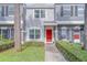Townhouse exterior with red front door, updated landscaping, and neutral stucco facade at 367 Countryside Key Blvd, Oldsmar, FL 34677