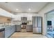 Well-equipped kitchen with stainless steel appliances, two-tone cabinetry, and a view to patio at 367 Countryside Key Blvd, Oldsmar, FL 34677