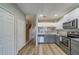 Stylish kitchen with gray and white cabinets, stainless appliances, and hardwood floors at 367 Countryside Key Blvd, Oldsmar, FL 34677
