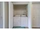 Functional laundry room featuring a washer and dryer, plus storage shelves at 367 Countryside Key Blvd, Oldsmar, FL 34677