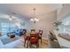 Inviting living room features a comfortable blue sofa, wood floors, and modern decor with dining area at 367 Countryside Key Blvd, Oldsmar, FL 34677