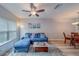 Open-concept living room with light wood floors, stylish decor, and comfortable seating at 367 Countryside Key Blvd, Oldsmar, FL 34677
