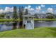 Scenic gazebo overlooking pond, surrounded by lush greenery and townhomes at 367 Countryside Key Blvd, Oldsmar, FL 34677