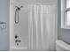 Bathroom featuring a shower with a curtain, a new toilet, and sleek fixtures at 3721 Casaba Loop, Valrico, FL 33596